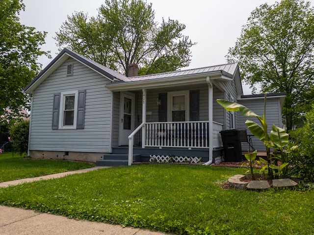408 Olive St, Greenfield, OH 45123 - view of front of home with covered porch, a chimney, metal roof, and a front lawn