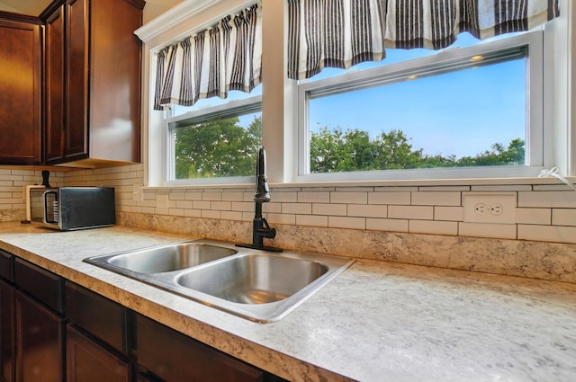 459 Wingate Pl, Mount Sterling, OH 43143 - kitchen featuring a sink, light countertops, backsplash, and dark brown cabinetry