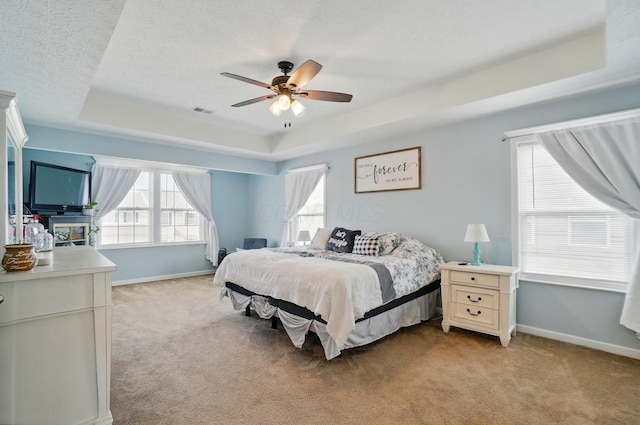 459 Wingate Pl, Mount Sterling, OH 43143 - bedroom featuring a tray ceiling, light colored carpet, baseboards, ceiling fan, and a textured ceiling