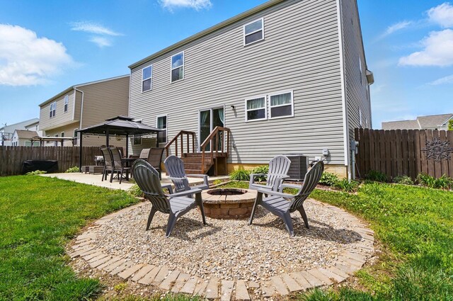 459 Wingate Pl, Mount Sterling, OH 43143 - rear view of house with a gazebo, a patio, a fire pit, and central air condition unit