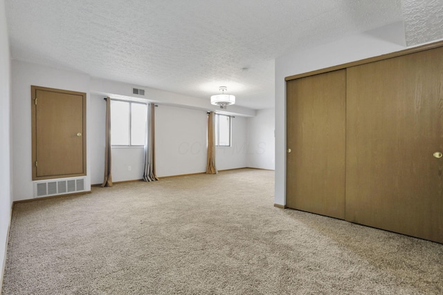 3939 Karl Rd Unit 206, Columbus, OH 43224 - unfurnished bedroom with carpet floors, a textured ceiling, and a closet
