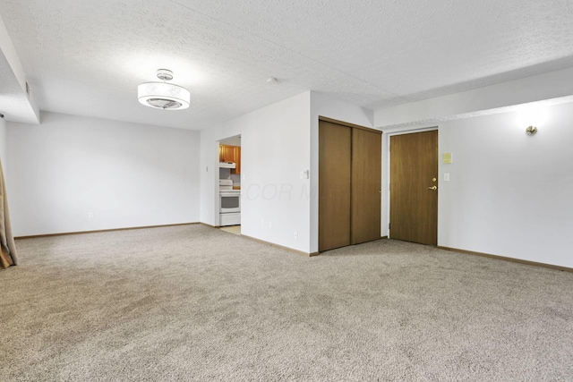 3939 Karl Rd Unit 206, Columbus, OH 43224 - unfurnished room with carpet flooring, baseboards, and a textured ceiling