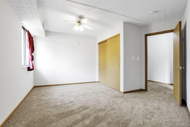 3939 Karl Rd Unit 206, Columbus, OH 43224 - unfurnished bedroom featuring carpet floors, baseboards, a textured ceiling, and a closet