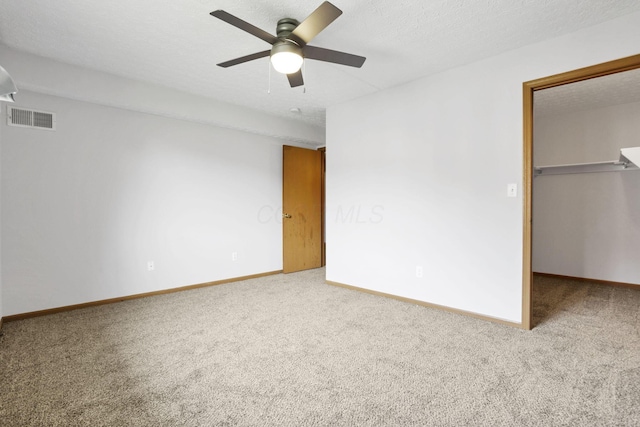 3939 Karl Rd Unit 206, Columbus, OH 43224 - unfurnished bedroom with carpet floors, a spacious closet, baseboards, and ceiling fan