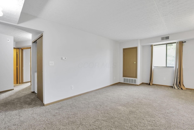 3939 Karl Rd Unit 206, Columbus, OH 43224 - empty room with carpet, a textured ceiling, and baseboards