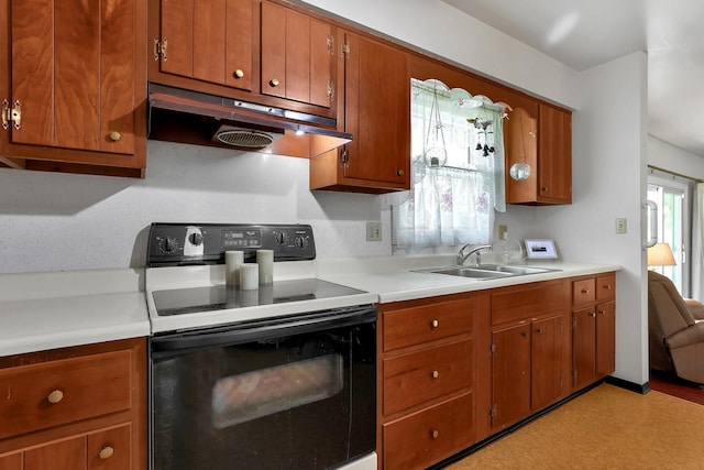 3723 Klibreck Dr, Columbus, OH 43228 - kitchen featuring electric range, under cabinet range hood, a sink, brown cabinetry, and light countertops