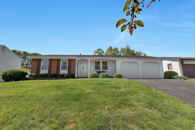 3723 Klibreck Dr, Columbus, OH 43228 - ranch-style house featuring a garage, asphalt driveway, a front yard, and brick siding