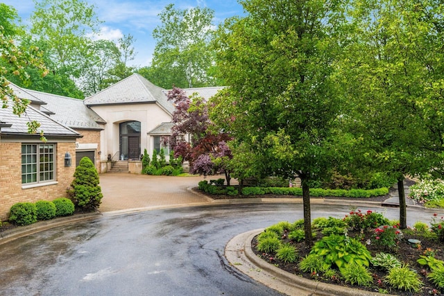 14 Lyonsgate Rd, Bexley, OH 43209 - view of front facade featuring curved driveway, stucco siding, and brick siding