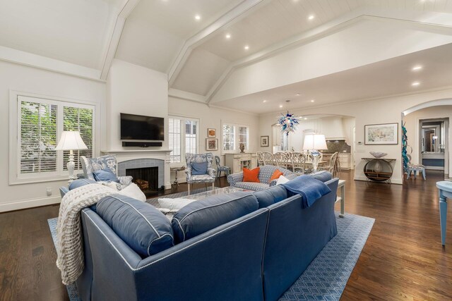14 Lyonsgate Rd, Bexley, OH 43209 - living room with arched walkways, healthy amount of natural light, a fireplace, dark wood-type flooring, and high vaulted ceiling