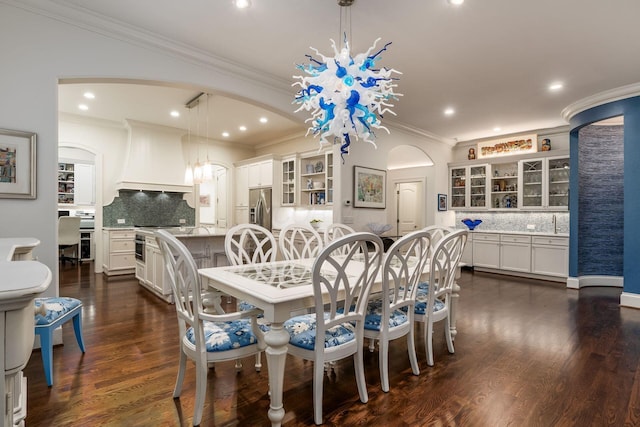 14 Lyonsgate Rd, Bexley, OH 43209 - dining space featuring ornamental molding, arched walkways, a chandelier, recessed lighting, and dark wood-type flooring