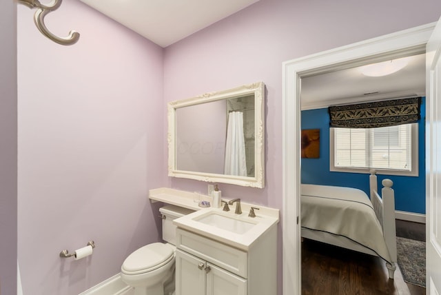 14 Lyonsgate Rd, Bexley, OH 43209 - bathroom with baseboards, vanity, wood finished floors, and toilet