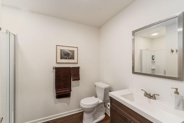 14 Lyonsgate Rd, Bexley, OH 43209 - bathroom with vanity, toilet, baseboards, wood finished floors, and a shower