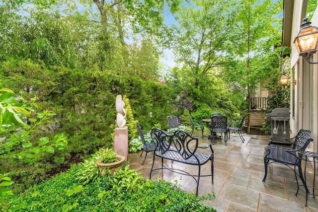 14 Lyonsgate Rd, Bexley, OH 43209 - view of patio / terrace with outdoor dining space, view of wooded area, and a grill