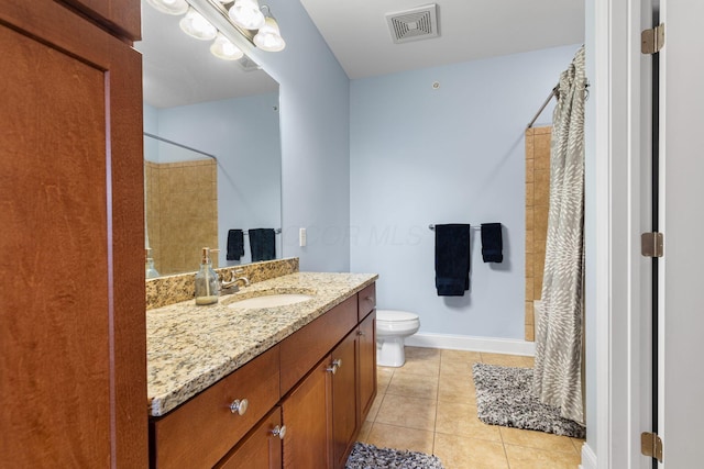 925 Ingleside Ave Unit 213, Columbus, OH 43215 - bathroom with vanity, toilet, a shower with shower curtain, tile patterned flooring, and baseboards