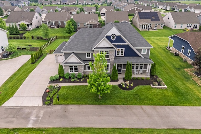3669 Audubon Ave, Hilliard, OH 43026 - view of front of house featuring stone siding, a residential view, driveway, and a shingled roof
