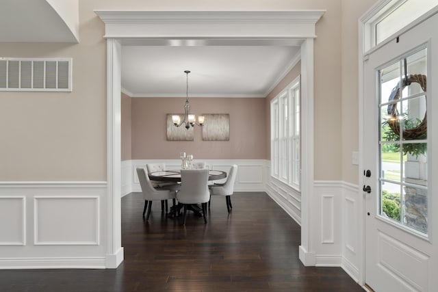 3669 Audubon Ave, Hilliard, OH 43026 - dining room featuring healthy amount of natural light, a chandelier, a wainscoted wall, dark wood-type flooring, and a decorative wall