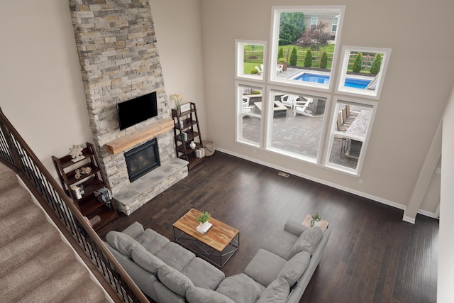 3669 Audubon Ave, Hilliard, OH 43026 - living room with baseboards, a stone fireplace, stairs, and wood finished floors