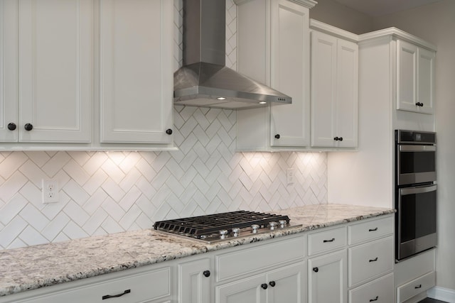 3669 Audubon Ave, Hilliard, OH 43026 - kitchen featuring wall chimney exhaust hood, appliances with stainless steel finishes, and white cabinetry