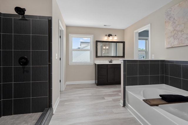 3669 Audubon Ave, Hilliard, OH 43026 - bathroom with a bath, vanity, tiled shower, and wood finished floors