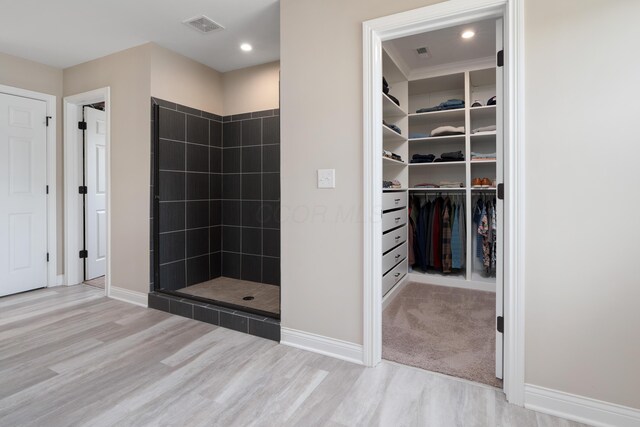 3669 Audubon Ave, Hilliard, OH 43026 - full bathroom featuring wood finished floors, a tile shower, a spacious closet, baseboards, and recessed lighting
