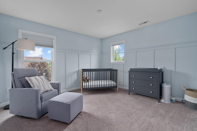 3669 Audubon Ave, Hilliard, OH 43026 - carpeted bedroom featuring a decorative wall, a nursery area, and wainscoting