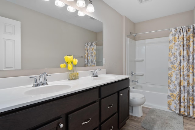 3669 Audubon Ave, Hilliard, OH 43026 - full bathroom featuring double vanity, shower / tub combo, wood finished floors, and toilet