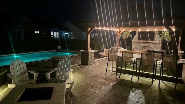 3669 Audubon Ave, Hilliard, OH 43026 - patio at twilight with outdoor dining space, a patio, and an outdoor pool