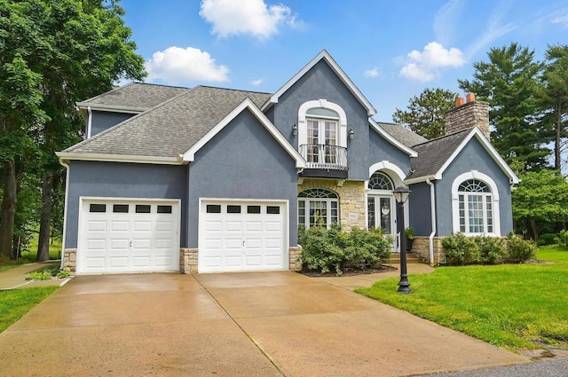 9146 Shawnee Trl, Powell, OH 43065 - view of front of home featuring stone siding, a balcony, stucco siding, and a garage
