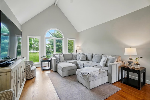 9146 Shawnee Trl, Powell, OH 43065 - living area featuring high vaulted ceiling, light wood-style floors, and beamed ceiling