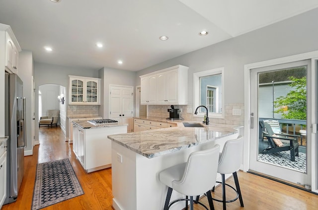 9146 Shawnee Trl, Powell, OH 43065 - kitchen with a sink, arched walkways, healthy amount of natural light, appliances with stainless steel finishes, and recessed lighting