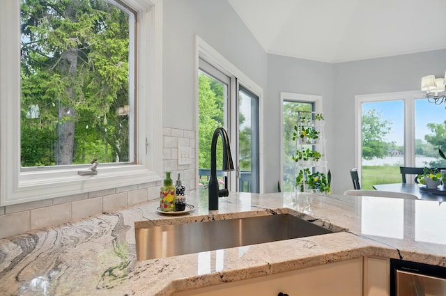 9146 Shawnee Trl, Powell, OH 43065 - kitchen featuring a sink, light stone countertops, and healthy amount of natural light