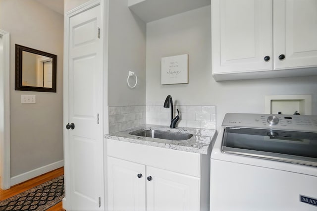 9146 Shawnee Trl, Powell, OH 43065 - washroom with washer / dryer, light wood-style floors, cabinet space, and baseboards
