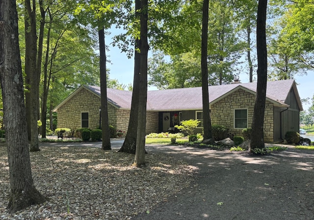 7326 State Route 19 Unit 2, Lots 27-30, Mount Gilead, OH 43338 - single story home with stone siding, driveway, roof with shingles, and a chimney