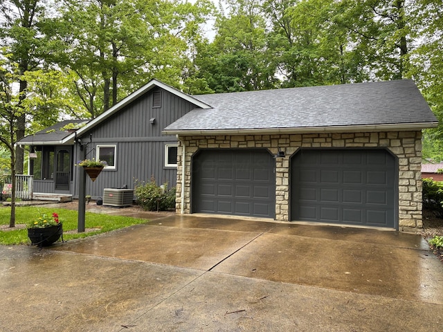 7326 State Route 19 Unit 2, Lots 27-30, Mount Gilead, OH 43338 - view of front of property featuring concrete driveway, an attached garage, cooling unit, a shingled roof, and board and batten siding