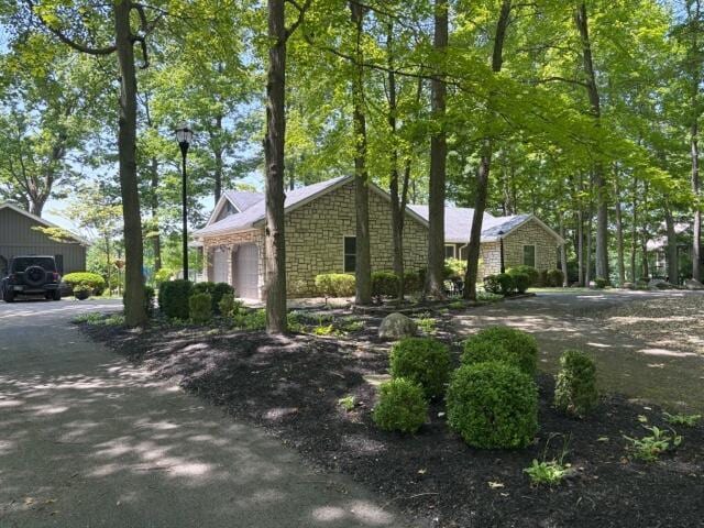 7326 State Route 19 Unit 2, Lots 27-30, Mount Gilead, OH 43338 - view of home's exterior with stone siding and a garage