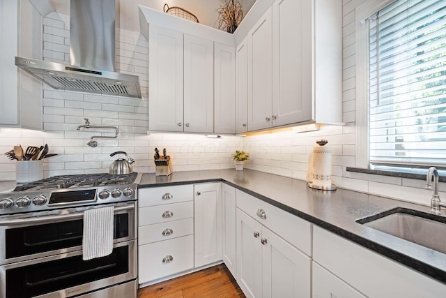 7326 State Route 19 Unit 2, Lots 27-30, Mount Gilead, OH 43338 - kitchen featuring double oven range, wall chimney range hood, white cabinetry, backsplash, and dark stone countertops