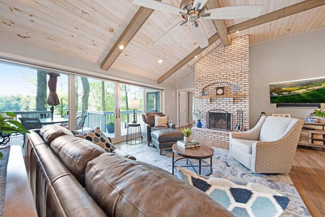 7326 State Route 19 Unit 2, Lots 27-30, Mount Gilead, OH 43338 - living room with wood finished floors, a wooden ceiling with exposed beams, a brick fireplace, ceiling fan, and high vaulted ceiling