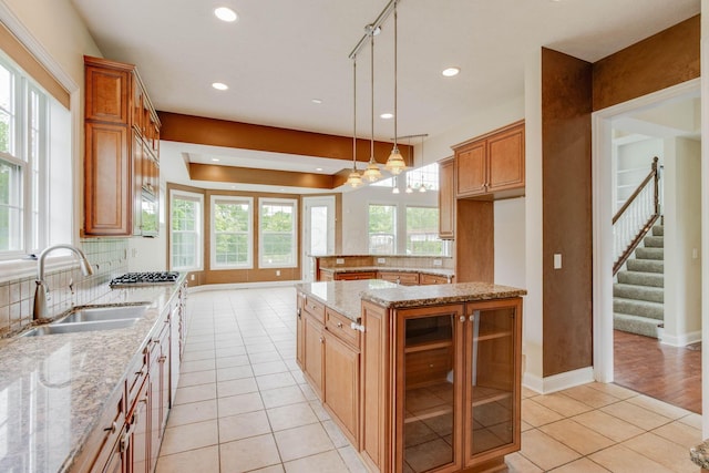 2898 Braden Way, Blacklick, OH 43004 - kitchen featuring a sink, light tile patterned flooring, a kitchen island, recessed lighting, and light stone countertops
