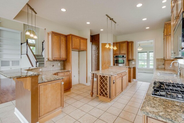 2898 Braden Way, Blacklick, OH 43004 - kitchen featuring a sink, a chandelier, oven, gas cooktop, and a peninsula