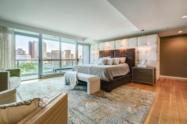 1 Miranova Pl Unit 1225, Columbus, OH 43215 - bedroom featuring light wood-style floors, recessed lighting, baseboards, and a view of city