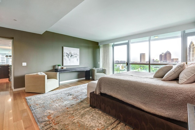 1 Miranova Pl Unit 1225, Columbus, OH 43215 - bedroom featuring wood finished floors, baseboards, and a city view