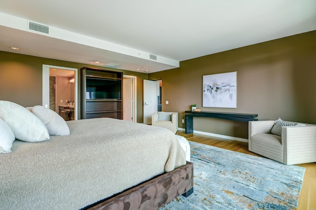 1 Miranova Pl Unit 1225, Columbus, OH 43215 - bedroom with wood finished floors, baseboards, recessed lighting, and ensuite bathroom