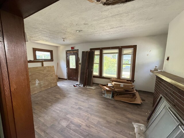 778 Berkeley Rd, Columbus, OH 43205 - living room with wood finished floors, a brick fireplace, and a textured ceiling