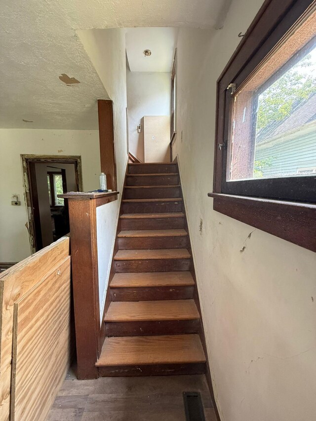 778 Berkeley Rd, Columbus, OH 43205 - stairway with wood finished floors, healthy amount of natural light, and a textured ceiling