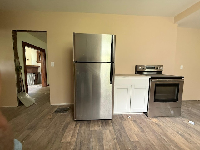 778 Berkeley Rd, Columbus, OH 43205 - kitchen with appliances with stainless steel finishes, wood finished floors, and white cabinetry