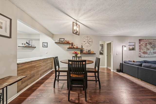 3137 Griggsview Ct Unit 3137, Columbus, OH 43221 - dining room featuring dark wood finished floors, a textured ceiling, and baseboards