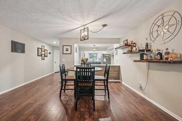 3137 Griggsview Ct Unit 3137, Columbus, OH 43221 - dining room featuring dark wood finished floors, baseboards, a textured ceiling, and a chandelier