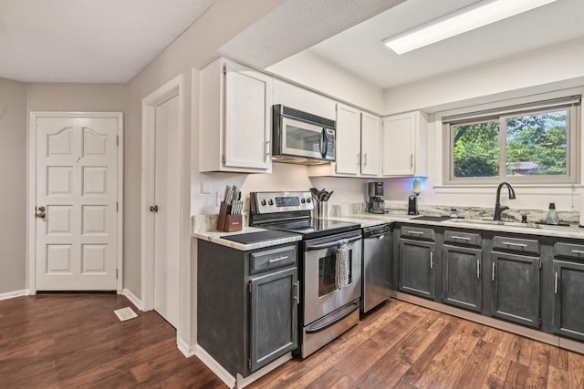 3137 Griggsview Ct Unit 3137, Columbus, OH 43221 - kitchen featuring appliances with stainless steel finishes, white cabinetry, and dark wood finished floors