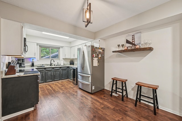 3137 Griggsview Ct Unit 3137, Columbus, OH 43221 - kitchen with appliances with stainless steel finishes, dark wood-type flooring, light countertops, white cabinetry, and open shelves