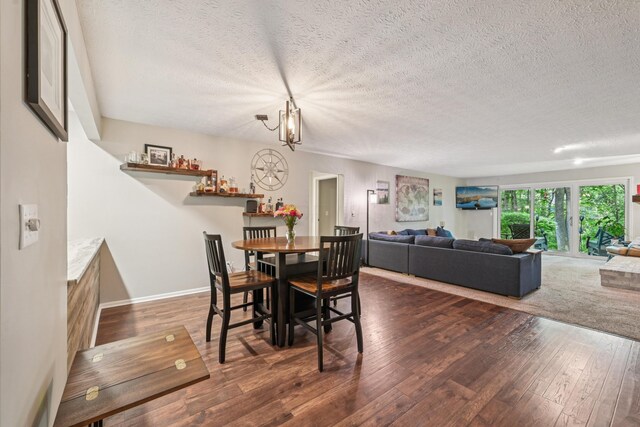 3137 Griggsview Ct Unit 3137, Columbus, OH 43221 - dining space with hardwood / wood-style flooring, a textured ceiling, a chandelier, and baseboards